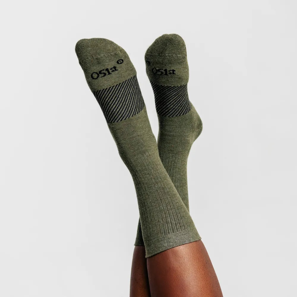 model wearing merino wool wicked comfort socks, crew in hunter green | OS1st