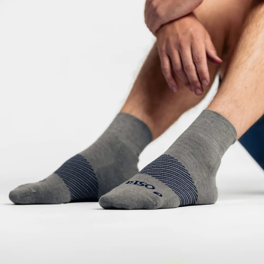 model wearing merino wool wicked comfort socks, quarter crew in grey| OS1st