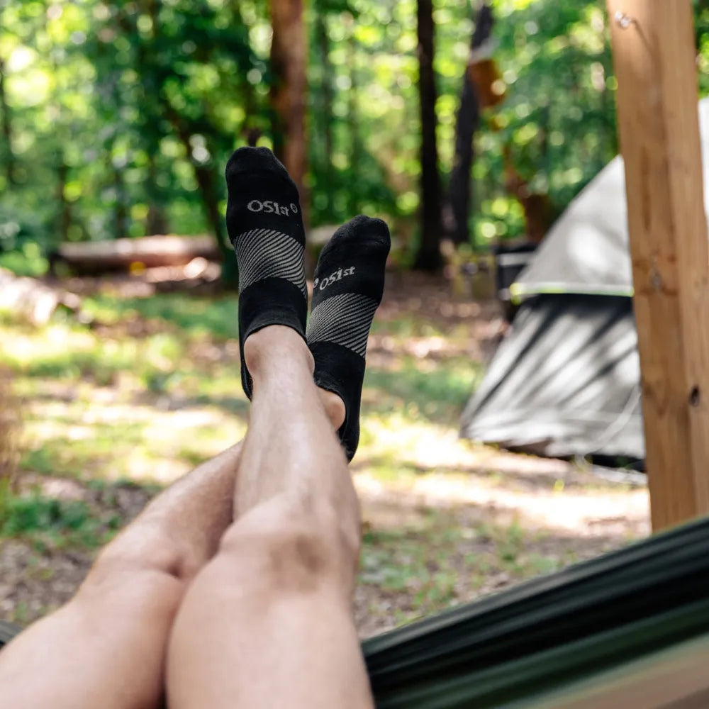 person sitting in hammock in the woods wearing no show black wicked comfort merino wool socks | OS1st