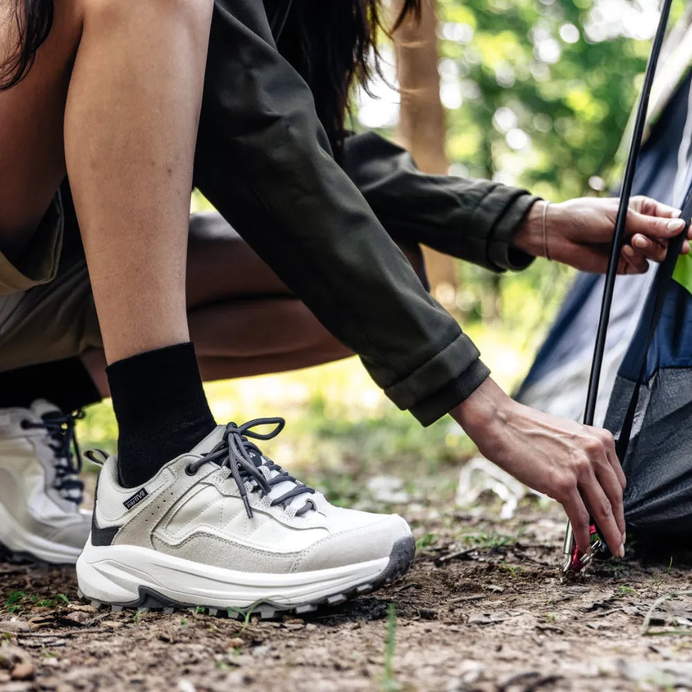 camper putting up tent, wearing quarter crew black wicked comfort merino wool socks | OS1st