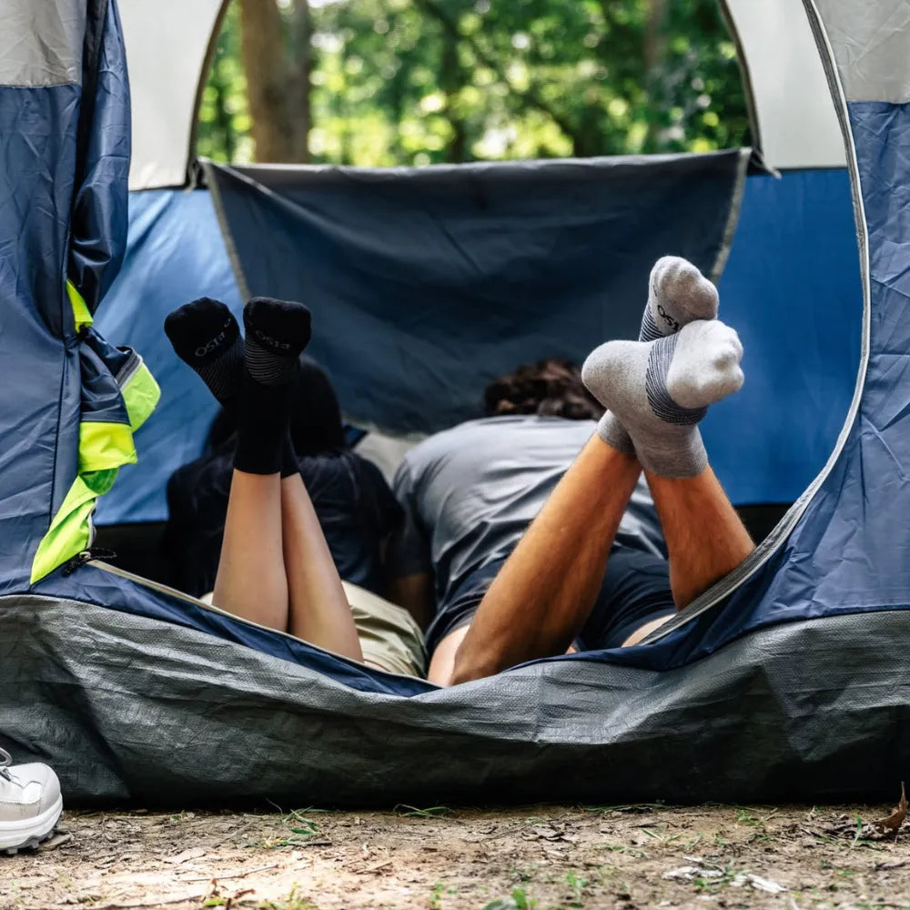 couple in camping tent wearing wicked comfort merino wool socks | OS1st