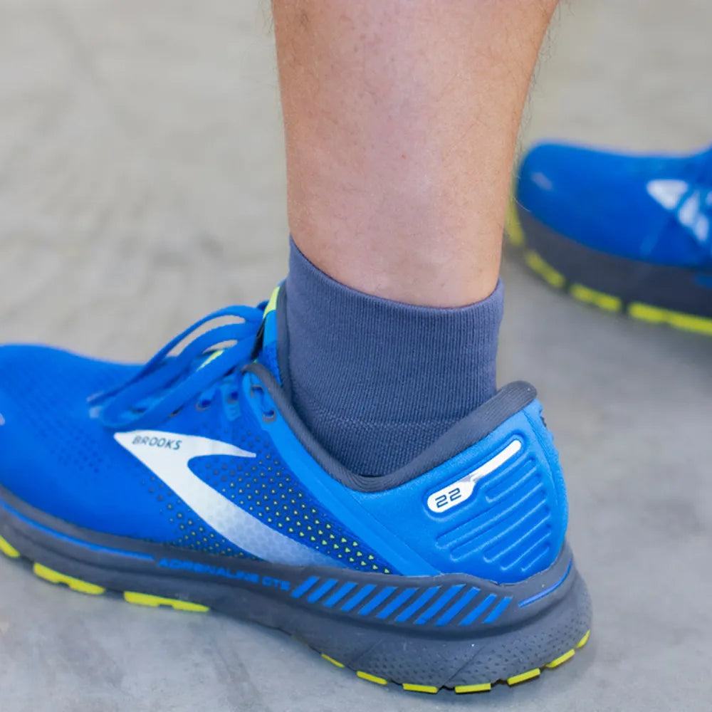 man wearing charcoal quarter crew wellness performance socks | OS1st