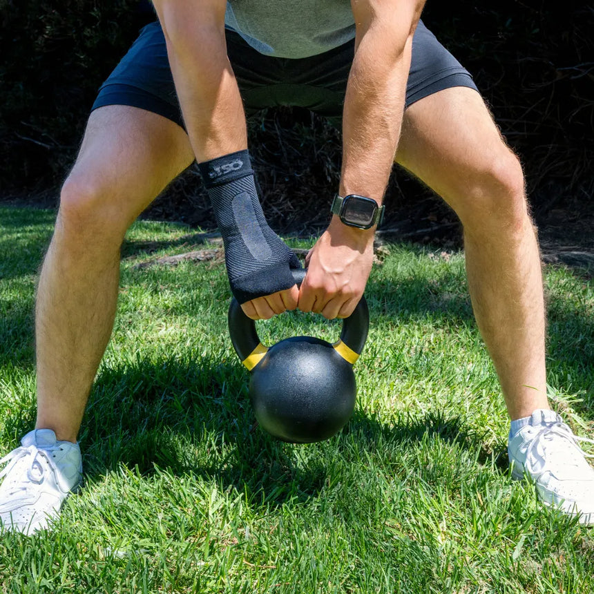 #color_black
man lifting weights wearing black ws6 wrist sleeve | OS1st