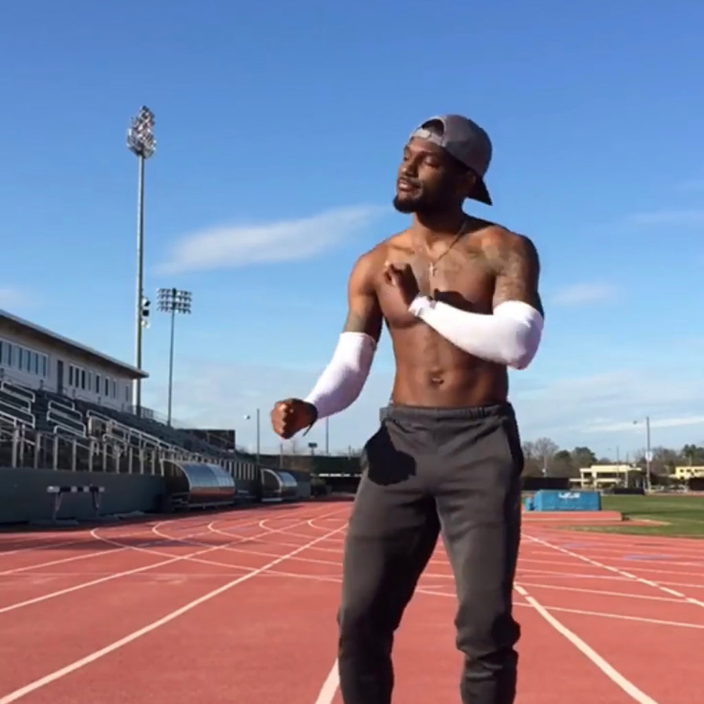 A man working out shown wearing two AS6 performance arm sleeves  | OS1st