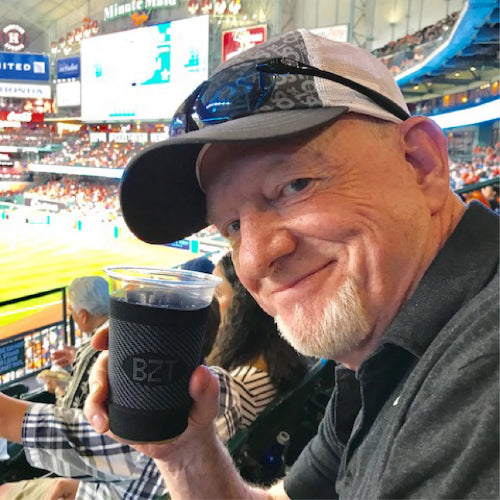 Dave holding a beverage that is in an OS1st beverage sleeve | OS1st