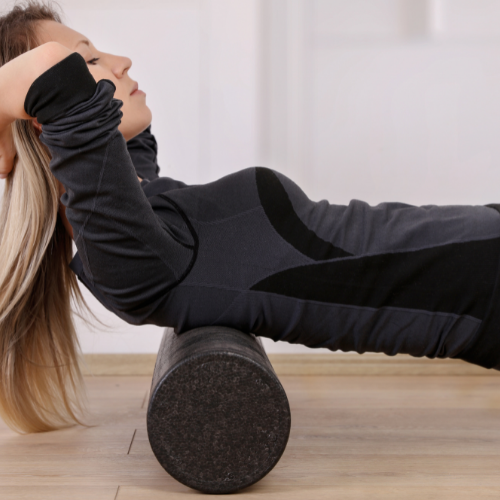 Lady using a foam roller to relieve muscles 