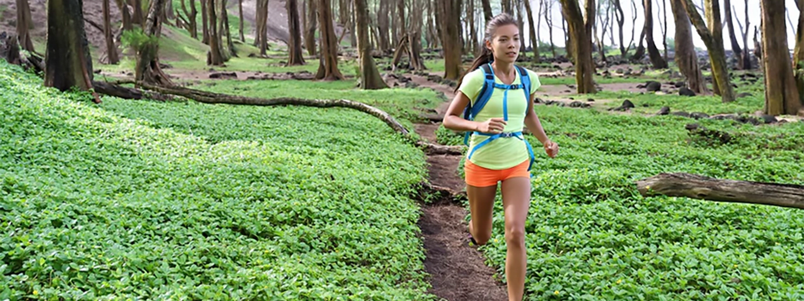 a woman running through an outdoor trail surrounded by beautiful scenery 