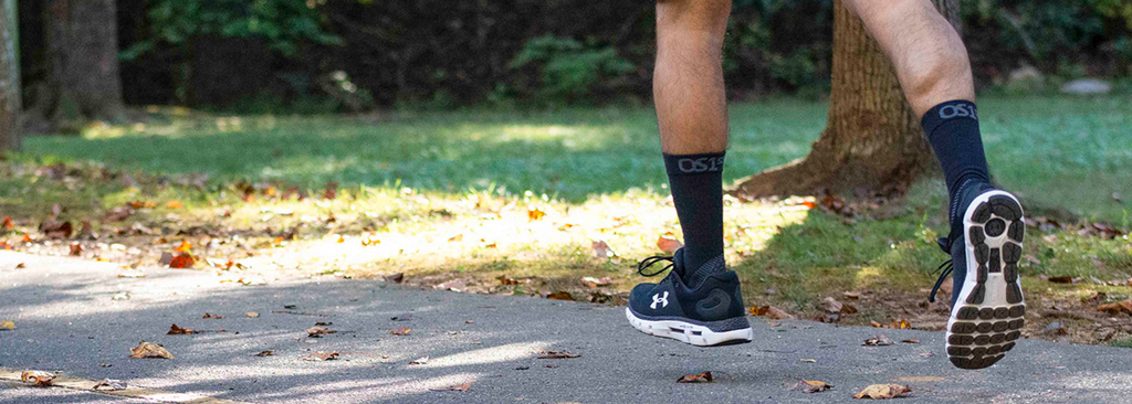 Runner wearing the OS1st Plantar fasciitis sock in merino wool - black