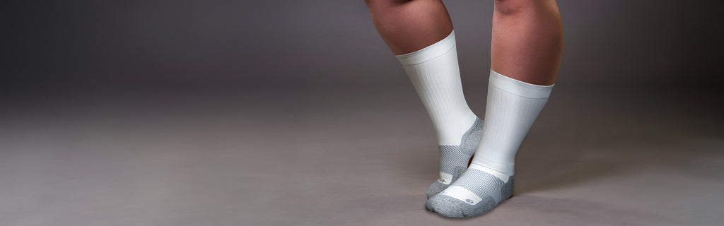 Model wearing OS1st Wide calf compression socks in white | OS1st