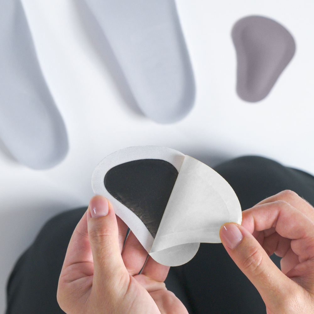 woman removing adhesive cover from met pad | OS1st