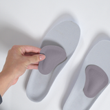 Woman placing/sticking met pad to shoe insole | OS1st