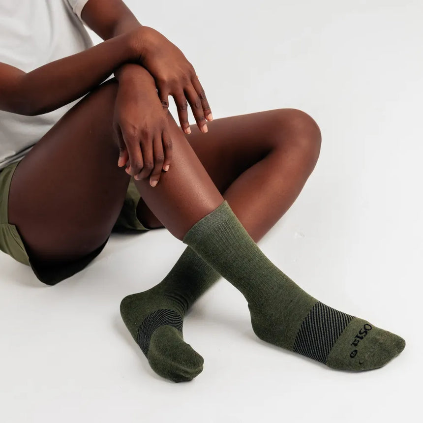 model wearing merino wool wicked comfort socks, crew in hunter green | OS1st
