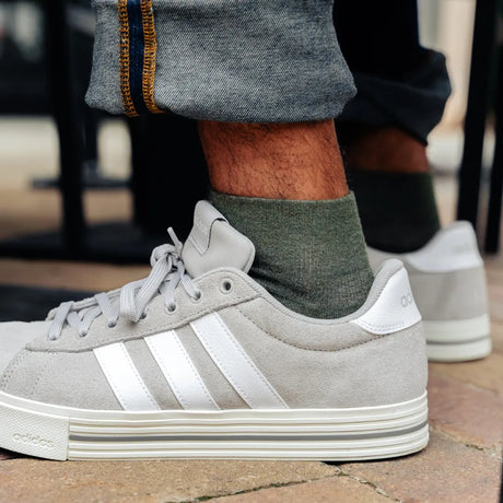 man wearing quarter crew hunter green wicked comfort merino wool socks with sneakers | OS1st