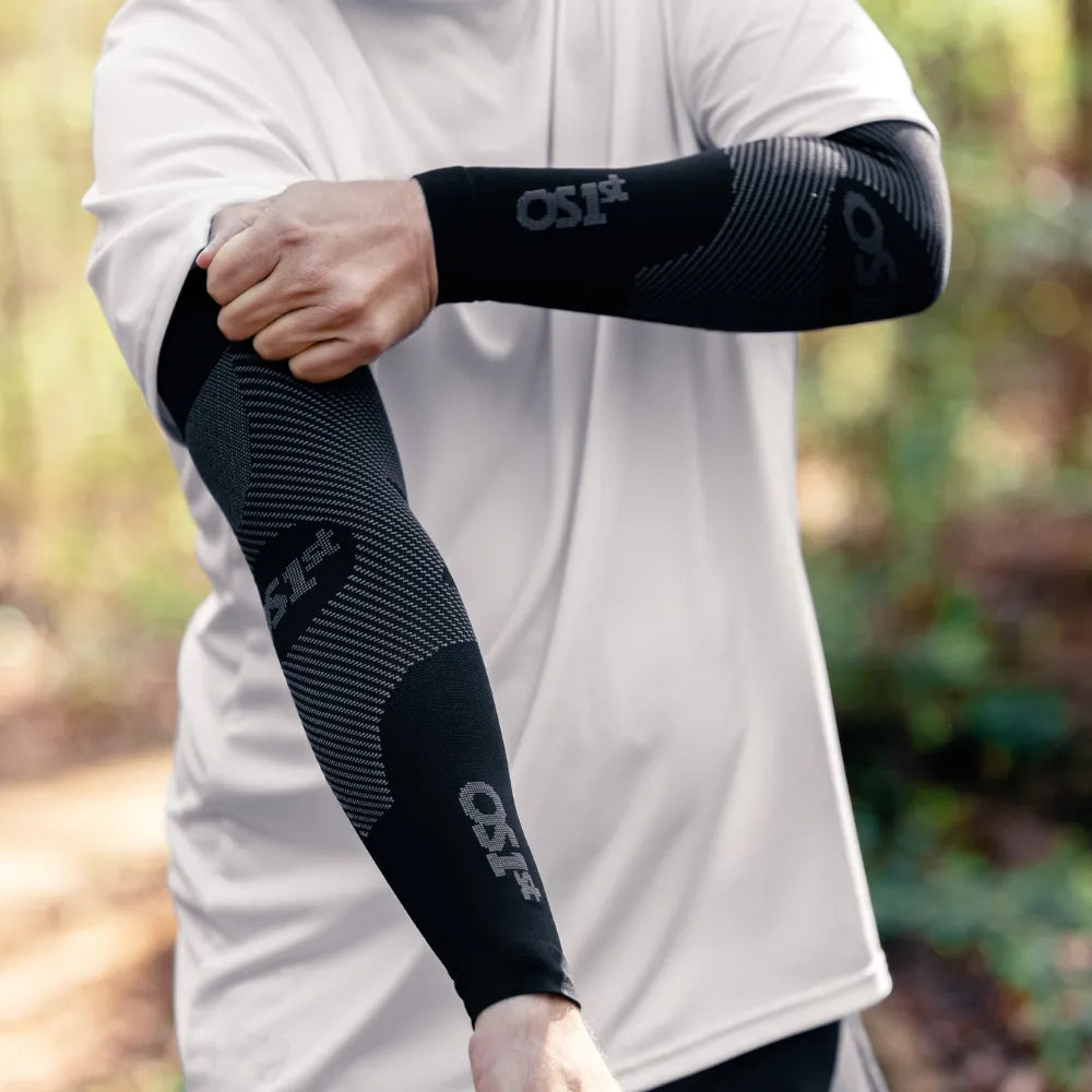 Person wearing black as6 arm sleeves on a trail run | OS1st