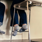 #color_grey
Person wearing grey bunion relief socks at home | OS1st