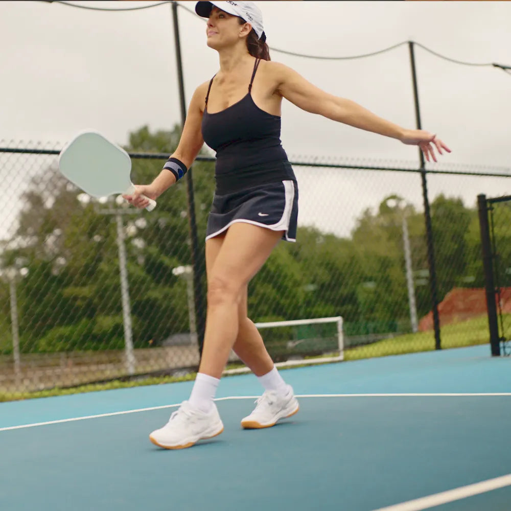 Athlete wearing black ES3 elbow sleeve while playing pickleball | OS1st