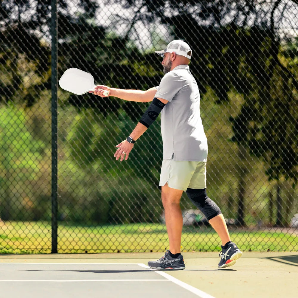 Pickleball athlete wearing es6 elbow brace, KS7 knee sleeve, and the pickleball sock | OS1st