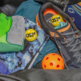 pickleball fresh snaps in a persons pickleball bag with shoes, clothing, a paddle, a pickleball, and a pair of the pickleball socks | OS1st