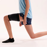 athlete wearing QS4 quad sleeve and black no show wicked comfort socks