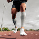 athlete wearing grey thin air performance socks and sleeves | OS1st