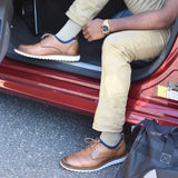 #color_tan
man traveling wearing wellness compression socks in tan | OS1st