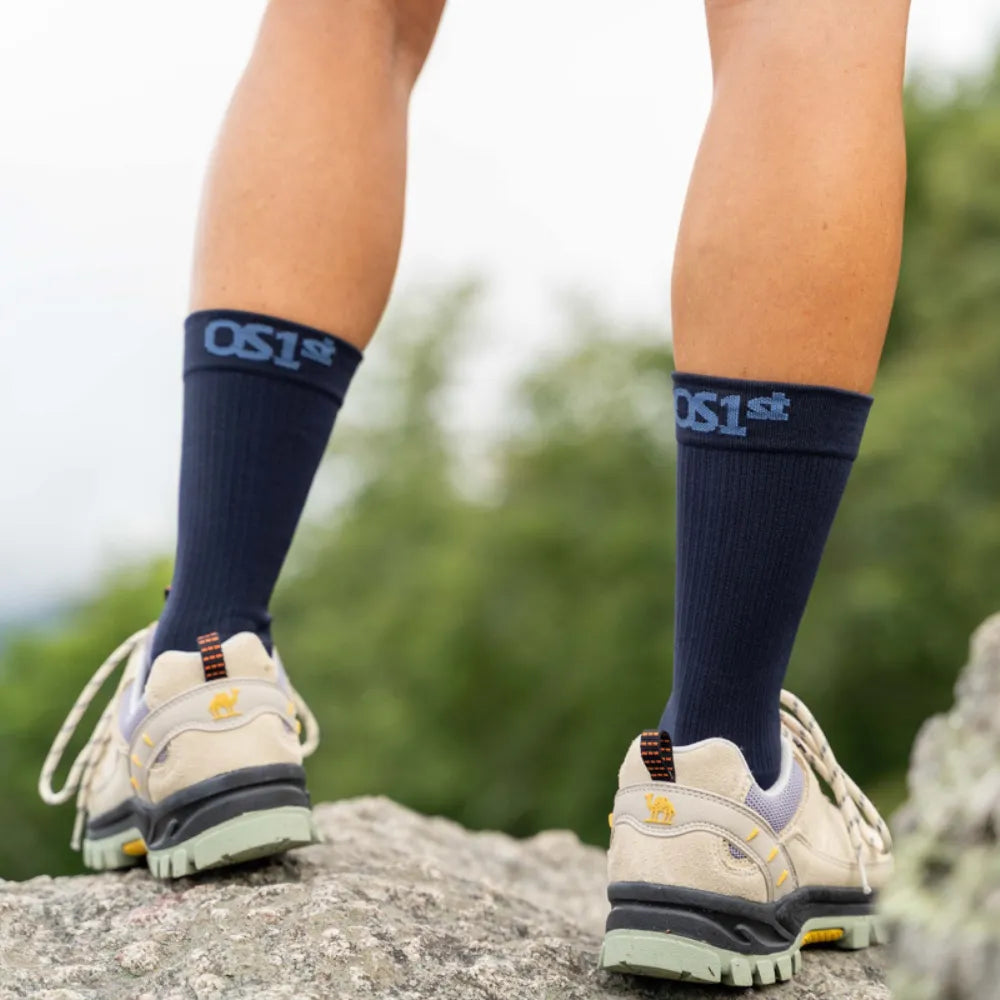 hiker wearing wellness performance socks in navy | OS1st