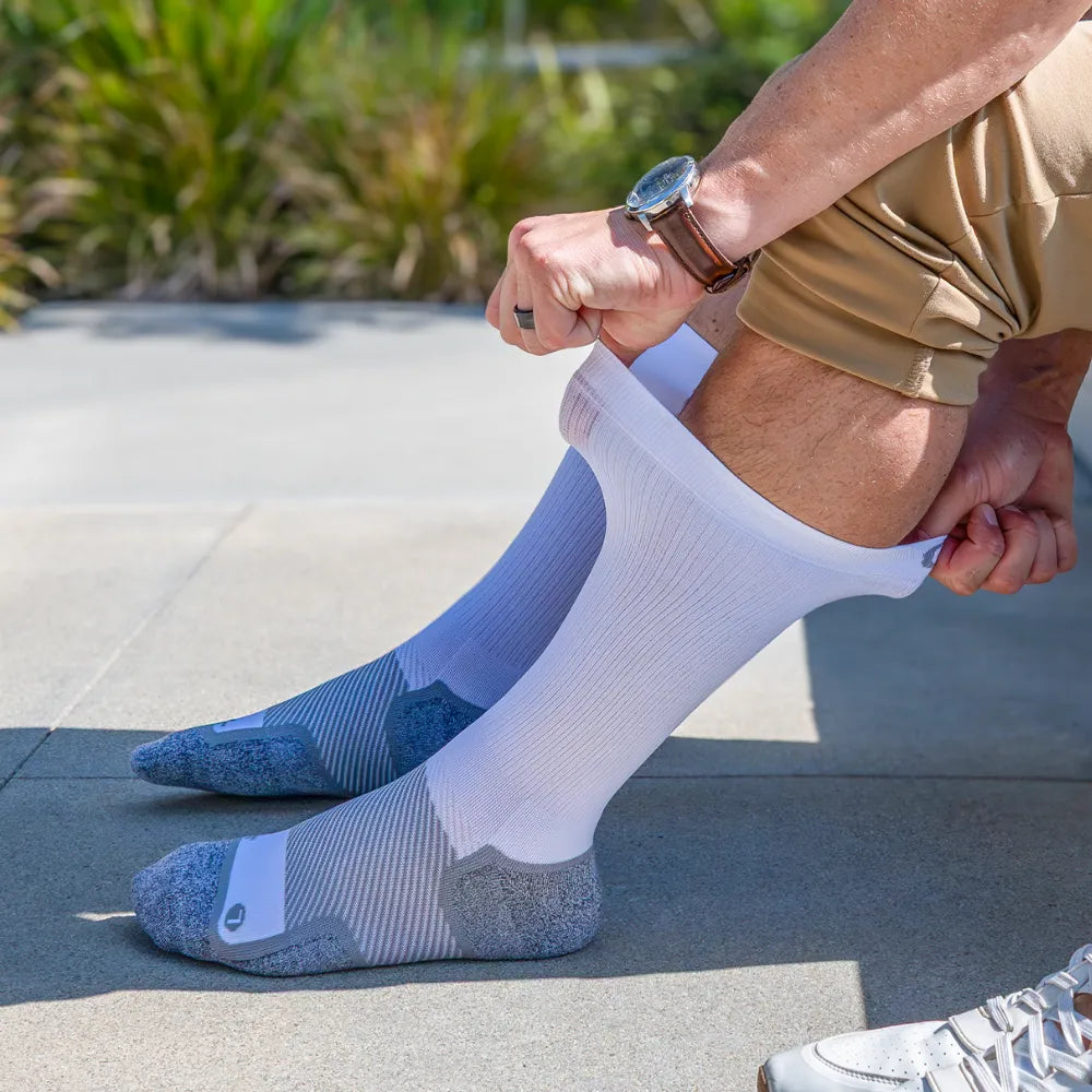 man showing stretch of wide width wellness performance socks | OS1st