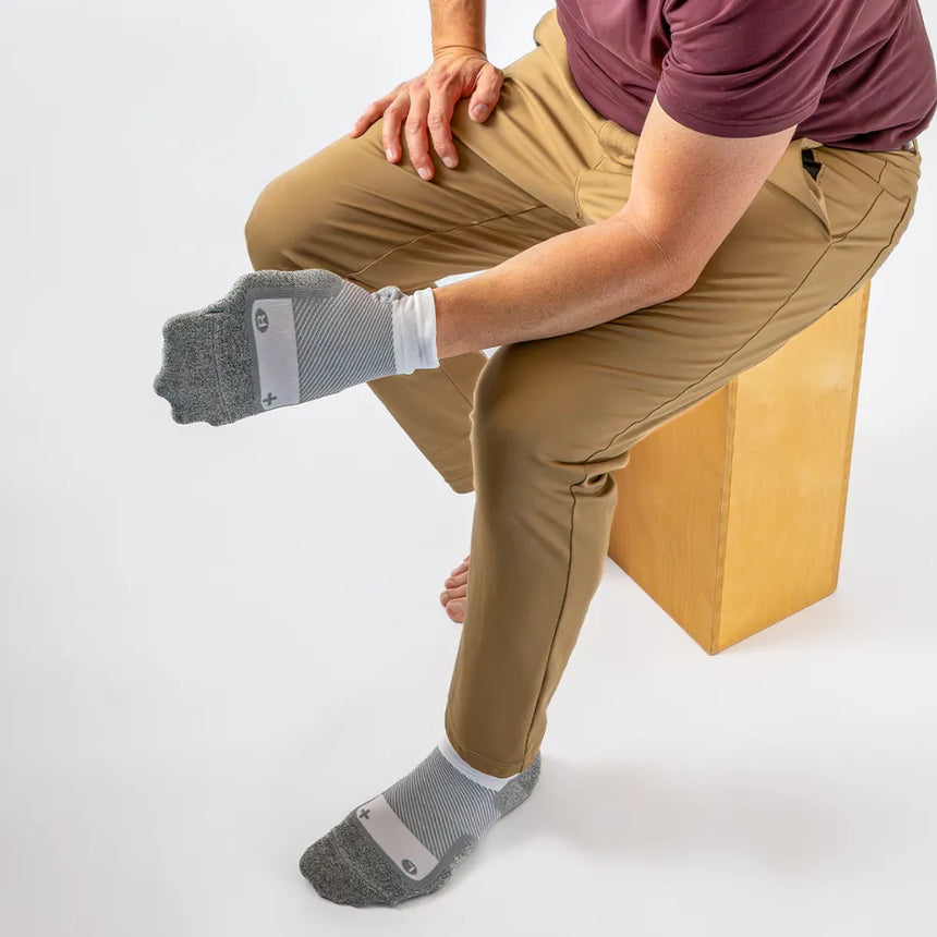 man showing stretch of wide wellness performance socks | OS1st