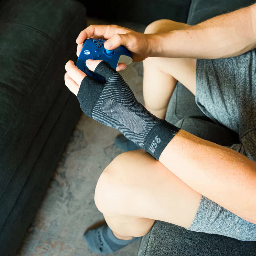 #color_black
person wearing ws6 wrist sleeve while playing video games | OS1st