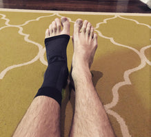 The AF7 Ankle Bracing Sleeve shown in black on a man's foot | OS1st