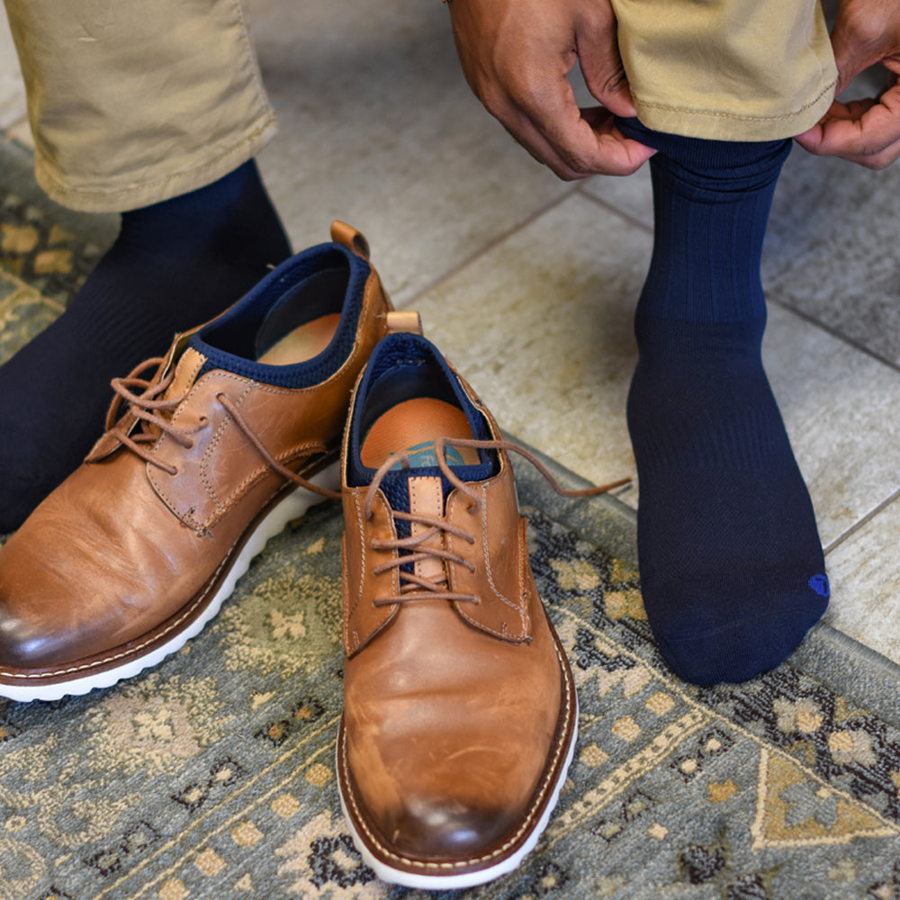 a man wearing the TS5 travel socks in the navy color