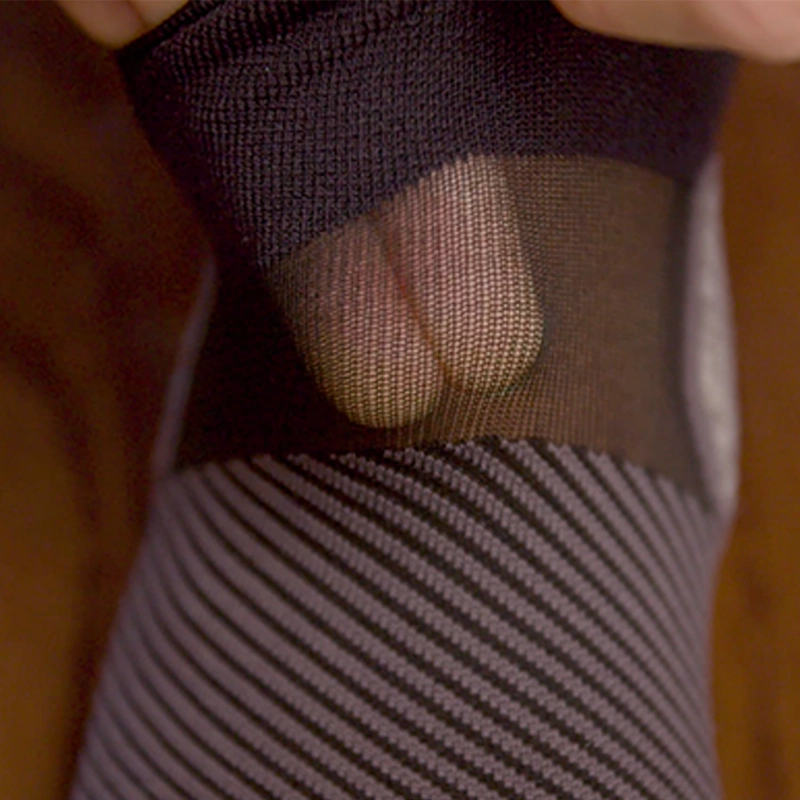 Close up of person showing the thin breathable fabric of the AC4 Active Comfort Socks no show length in black | OS1st
