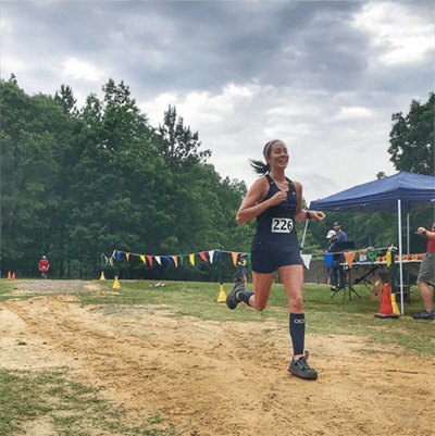 woman running in the CS6 performance calf sleeves | OS1st