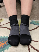 a person wearing the black quarter crew length FS4 socks